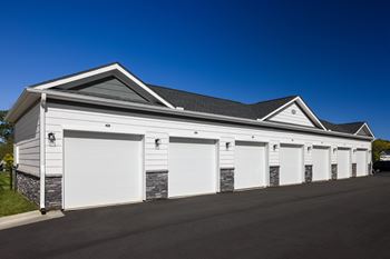 A row of white garage doors are closed.